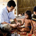 A physician from the Angkor Children's Hospital in Siem Reap Cambodia is examining a 6-year-old HIV positive girl inside her rural home.